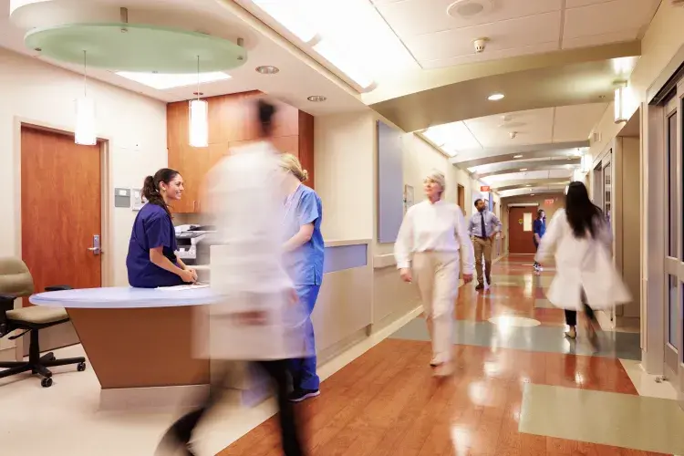 Doctors in motion in hospital hallway